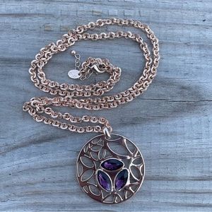Purple gem and rose gold colored chain necklace.